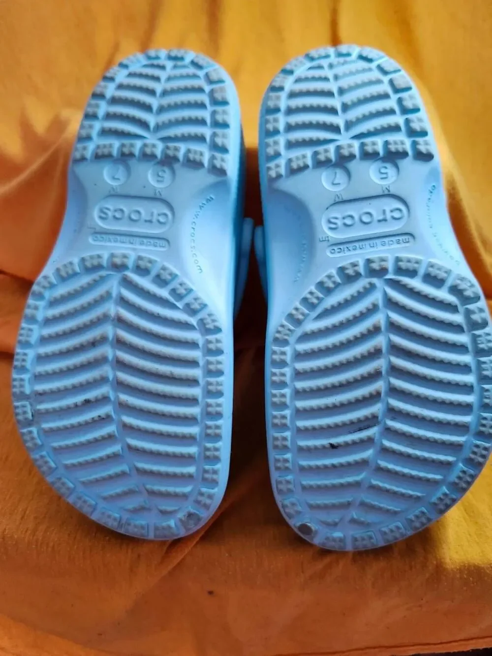 Crocs Classic clogs feature the iconic ventilated design and a swivel heel strap